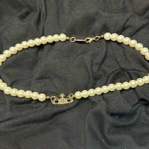 Add-on to bundle $5 Brand New. Pearl necklace with Saturn. 16 inches in length.